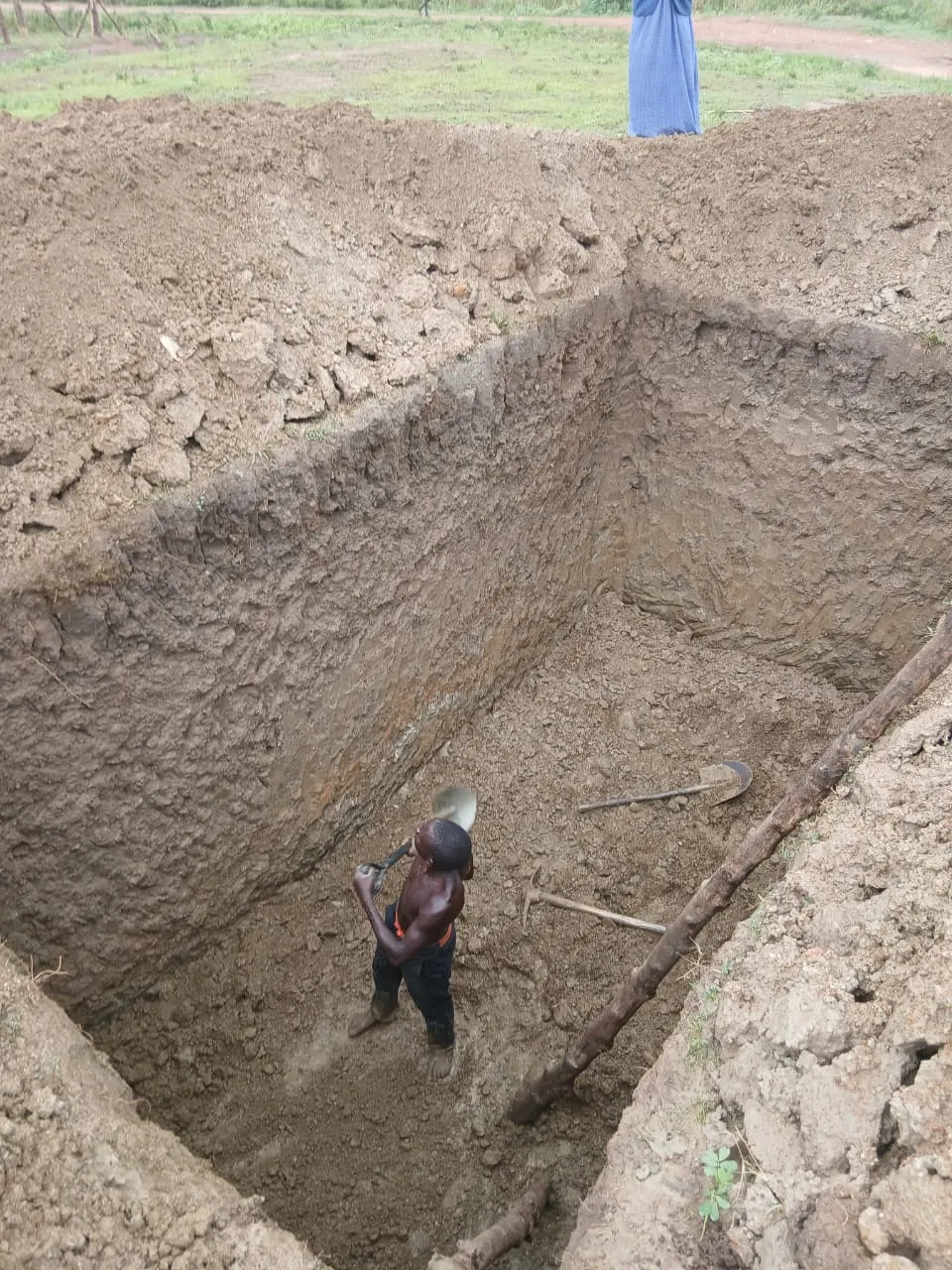 Worker digging the trench for the septic tank